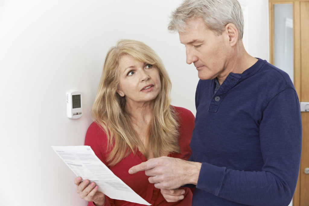 Worried couple reviewing their energy bill